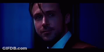Man In Suit And Tie Looking At Camera Blue Background GIF