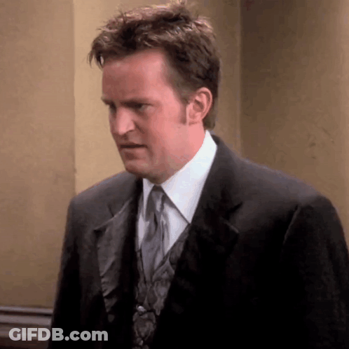 Man In Suit And Tie Looking At Camera GIF