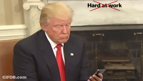 Man In Suit And Tie Looking At Phone Hard At Work Crossed Out Red GIF