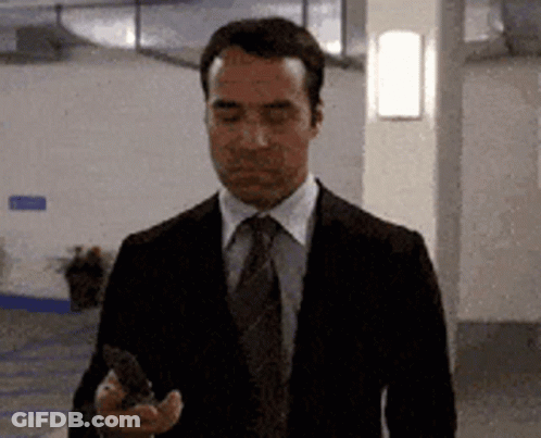 Man In Suit And Tie Looking At Phone GIF