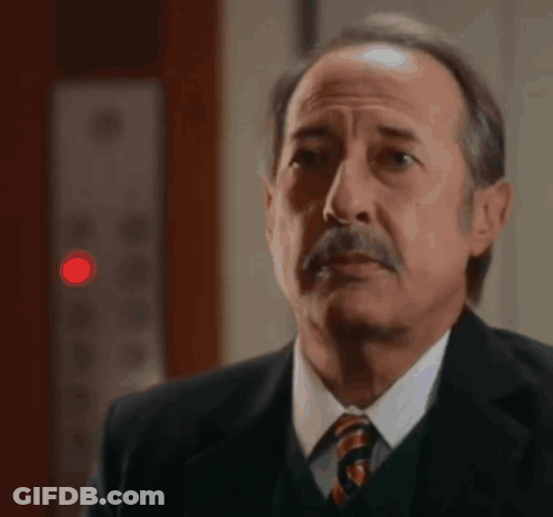 Man In Suit And Tie Looking At Something GIF