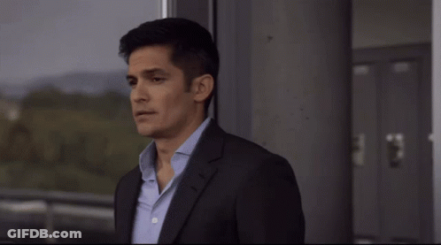 Man In Suit And Tie Looking Out Window GIF