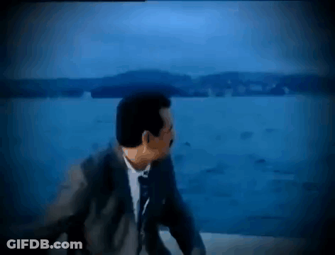 Man In Suit And Tie Looking Over Water GIF