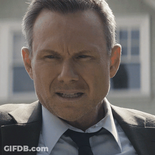 Man In Suit And Tie Looking Serious GIF