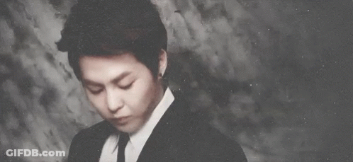Man In Suit And Tie Looks At Camera GIF
