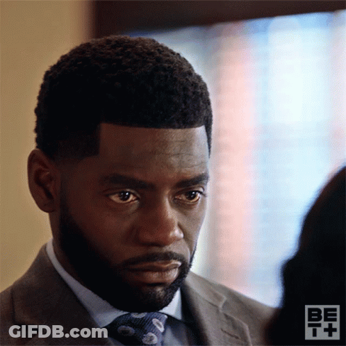 Man In Suit And Tie Looks At Other GIF