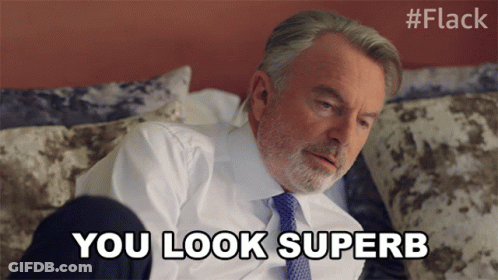 Man In Suit And Tie Lying On Bed Says You Look Superb GIF