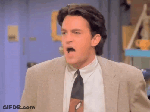 Man In Suit And Tie Making A Face GIF