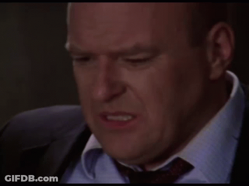 Man In Suit And Tie Making A Face GIF