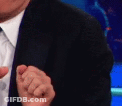 Man In Suit And Tie Making Fist GIF
