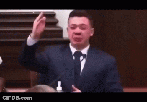 Man In Suit And Tie Making Funny Face At Microphone GIF