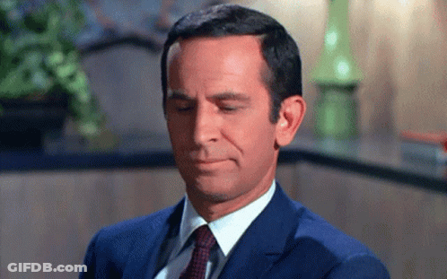Man In Suit And Tie Making Funny Face GIF