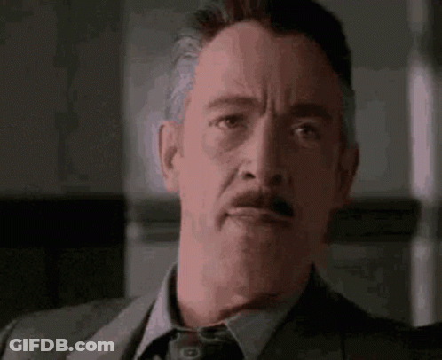 Man In Suit And Tie Making Funny Face GIF