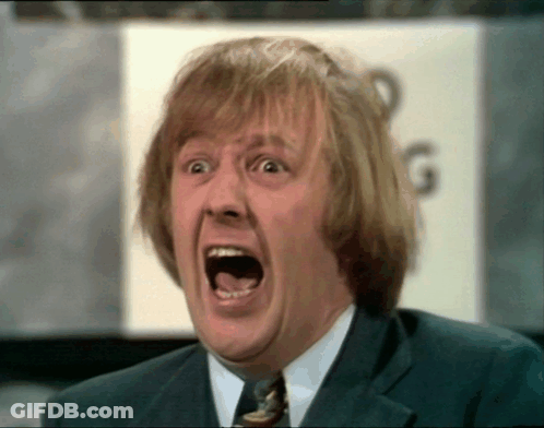 Man In Suit And Tie Making Funny Face GIF