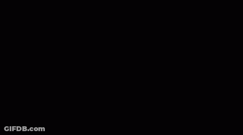 Man In Suit And Tie Making Funny Face With Remote Control GIF