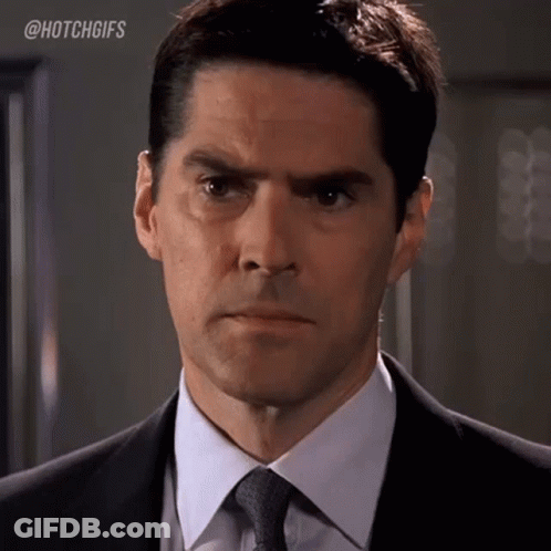 Man In Suit And Tie Making Serious Face GIF