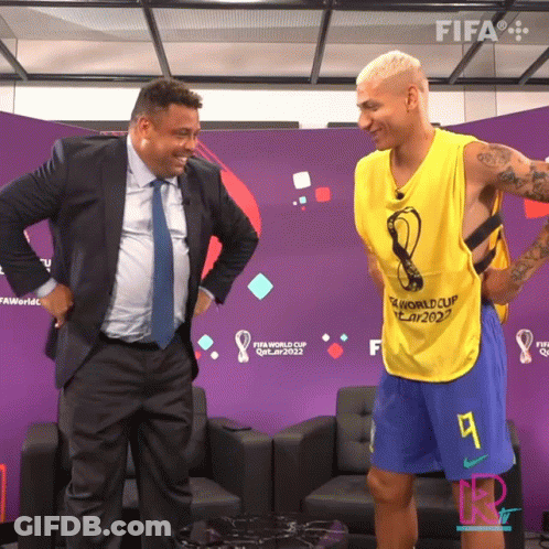 Man In Suit And Tie Next To FIFA World Cup Qatar 2022 Vest GIF