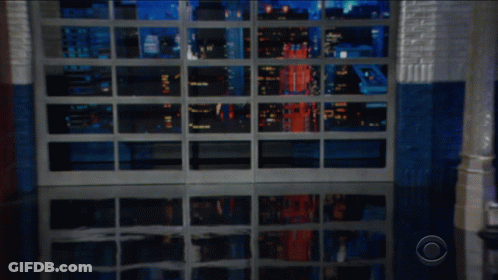 Man In Suit And Tie Next To Is Potato Sign GIF