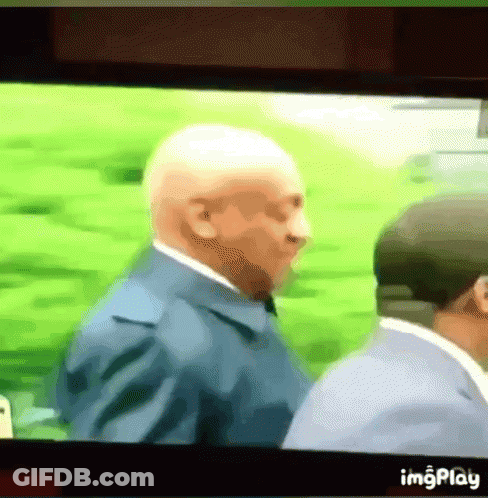 Man In Suit And Tie Next To Man In Hat GIF