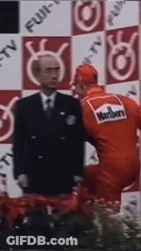 Man In Suit And Tie Next To Man In Red Marlboro Uniform GIF
