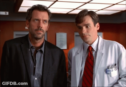 Man In Suit And Tie Next To Man In White Coat GIF