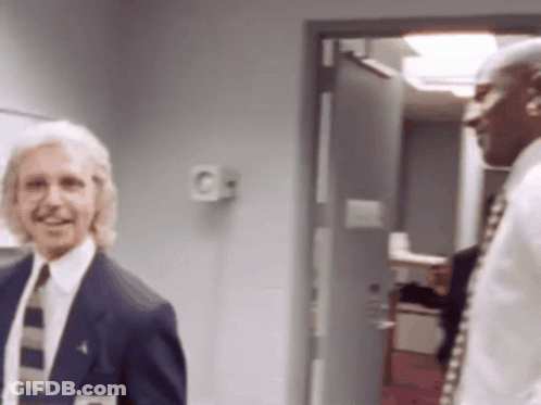 Man In Suit And Tie Next To Man In White Shirt GIF
