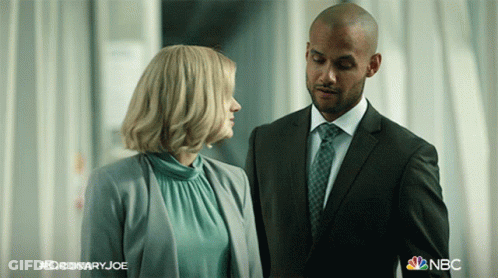 Man In Suit And Tie Next To Woman In Blue GIF