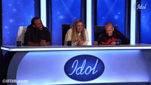 Man In Suit And Tie Next To Woman In Blue Uniform GIF