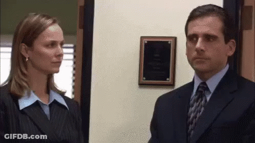 Man In Suit And Tie Next To Woman In Business Suit GIF