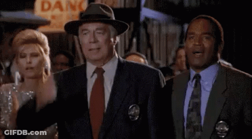 Man In Suit And Tie Next To Woman In Dress GIF