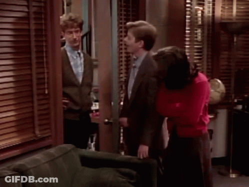 Man In Suit And Tie Next To Woman In Red Sweater GIF