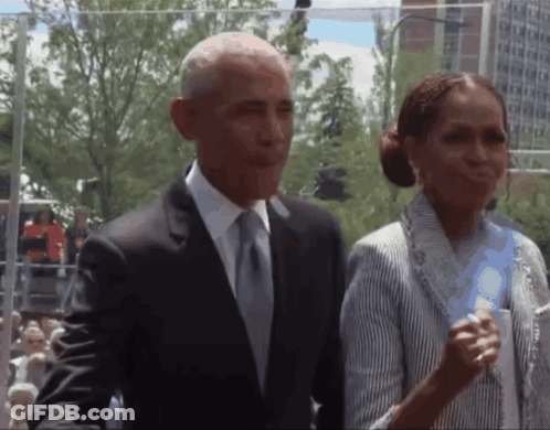 Man In Suit And Tie Next To Woman In Striped Shirt GIF