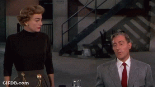 Man In Suit And Tie Next To Woman GIF