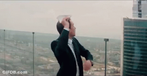 Man In Suit And Tie On Balcony Overlooking City GIF