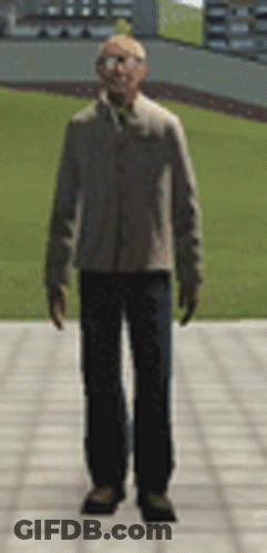 Man In Suit And Tie On Sidewalk In Front Of Field GIF