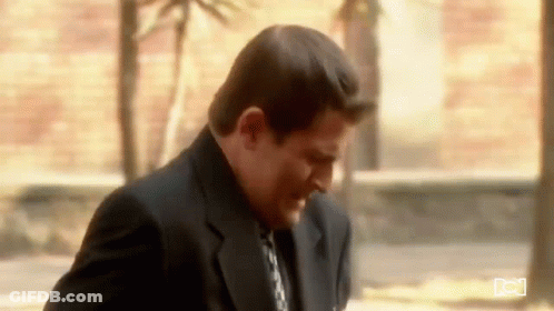 Man In Suit And Tie On Sidewalk GIF