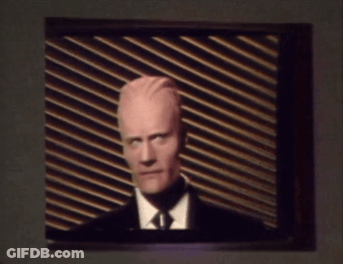 Man In Suit And Tie On TV GIF