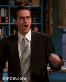 Man In Suit And Tie Pointing At Camera Saying Hey GIF