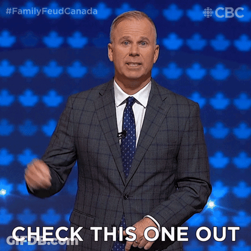 Man In Suit And Tie Pointing Saying Check This One Out GIF