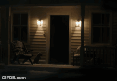 Man In Suit And Tie Projected Onto Door GIF