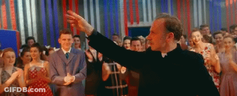 Man In Suit And Tie Pushing Man In Wheelchair GIF