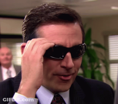 Man In Suit And Tie Putting On Sunglasses GIF