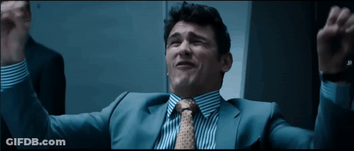 Man In Suit And Tie Raising Arms GIF