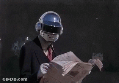 Man In Suit And Tie Reading Newspaper With Futuristic Helmet GIF
