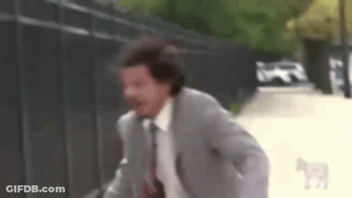 Man In Suit And Tie Running With Dog GIF