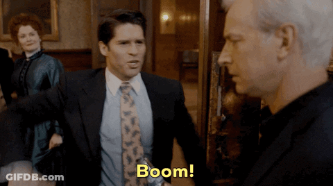 Man In Suit And Tie Saying Boom GIF