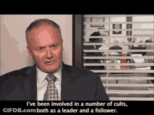Man In Suit And Tie Saying Cults GIF