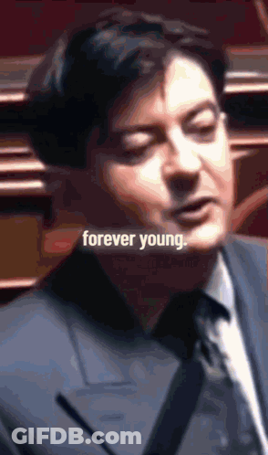 Man In Suit And Tie Saying Forever Young GIF