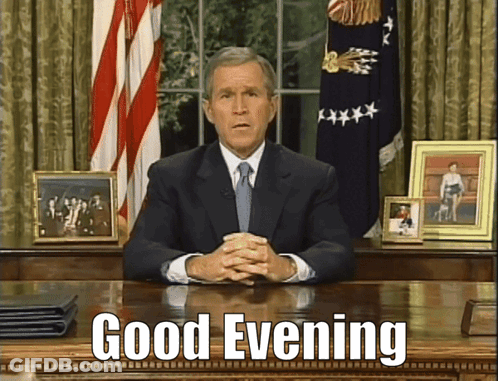 Man In Suit And Tie Saying Good Evening GIF