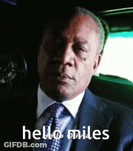 Man In Suit And Tie Saying Hello Miles GIF